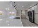 Bright, open kitchen with stainless steel appliances and a large center island with cooktop and stone countertops at 2061 S Peninsula Dr, Daytona Beach, FL 32118