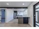 Open concept kitchen features stainless appliances, breakfast bar, beam and new floors at 2061 S Peninsula Dr, Daytona Beach, FL 32118