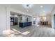 Open concept kitchen and dining area with gray wood floors, recessed lighting, and blue kitchen island at 2061 S Peninsula Dr, Daytona Beach, FL 32118