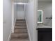 Stairway leading to upper level with wood-look treads and access to a modern bathroom at 2061 S Peninsula Dr, Daytona Beach, FL 32118