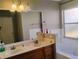 Bathroom featuring a double sink vanity, framed mirror, and a soaking tub at 250 Sir Phillips Dr, Davenport, FL 33837