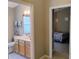 Bathroom with a single sink vanity and a door leading to the main bedroom at 250 Sir Phillips Dr, Davenport, FL 33837