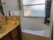 A bright bathroom features a large bathtub and tiled walls, creating a clean and inviting space at 250 Sir Phillips Dr, Davenport, FL 33837