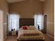 Comfortable bedroom features a plush upholstered bed and neutral decor at 250 Sir Phillips Dr, Davenport, FL 33837