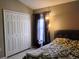Bedroom with a bed, closet, and neutral walls at 250 Sir Phillips Dr, Davenport, FL 33837