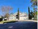Charming single Gathering home featuring a two-car garage, well-manicured lawn, and mature landscaping at 250 Sir Phillips Dr, Davenport, FL 33837
