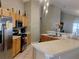 Kitchen featuring stainless steel appliances, wooden cabinetry, and adjacent breakfast bar at 250 Sir Phillips Dr, Davenport, FL 33837