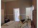 Comfortable main bedroom featuring neutral tones and a door leading to the main bathroom and walk-in closet at 250 Sir Phillips Dr, Davenport, FL 33837
