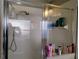 An enclosed shower with a variety of personal care products, providing a clean and functional space at 250 Sir Phillips Dr, Davenport, FL 33837