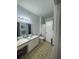 Bathroom features a large vanity, a toilet, and a shower-tub combo with a curtain at 2558 Robert Trent Jones Dr # 1412, Orlando, FL 32835