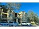 Apartment building featuring balconies and visible parking for residents and visitors at 2558 Robert Trent Jones Dr # 1412, Orlando, FL 32835