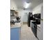 Kitchen with a black appliance package, tile flooring, and white cabinets at 2558 Robert Trent Jones Dr # 1412, Orlando, FL 32835