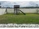 Spacious backyard featuring a playset, grassy area and a secure white fence at 2777 Monticello Way, Kissimmee, FL 34741