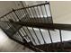 Elegant staircase with dark wood steps and decorative iron railing at 2777 Monticello Way, Kissimmee, FL 34741