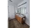 Bathroom with a double sink vanity, large mirror, and modern fixtures at 2812 Tower Rock St, Kissimmee, FL 34758