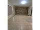 Bedroom with a large stone accent wall and tile flooring at 2812 Tower Rock St, Kissimmee, FL 34758