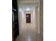 Hallway with tile flooring, neutral paint, and stone accent wall at 2812 Tower Rock St, Kissimmee, FL 34758