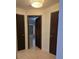 Hallway with tile flooring, neutral paint, and multiple doors at 2812 Tower Rock St, Kissimmee, FL 34758