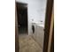 Laundry room featuring a white washer and dryer, shelving, and access to garage at 2812 Tower Rock St, Kissimmee, FL 34758