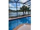 Relaxing pool area with picturesque lake views, perfect for outdoor enjoyment and serene lounging at 2812 Tower Rock St, Kissimmee, FL 34758