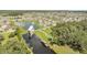 An aerial view showcasing a community with a lake, covered dock, seating areas, and well-maintained greenery at 2884 Nottel Dr, St Cloud, FL 34772
