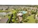 Aerial view of the community pool, playground, pond, and park area in the neighborhood at 2884 Nottel Dr, St Cloud, FL 34772