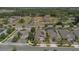 Aerial view showcasing residential homes with well-maintained yards in a community surrounded by trees at 2884 Nottel Dr, St Cloud, FL 34772