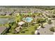 Aerial view of the community pool, splash pad, and playground with a pond and park area at 2884 Nottel Dr, St Cloud, FL 34772