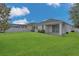 Wide backyard showing a large lawn area and the rear of the home at 2884 Nottel Dr, St Cloud, FL 34772