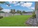 Manicured backyard featuring a well-maintained lawn and a privacy fence for added security at 2884 Nottel Dr, St Cloud, FL 34772