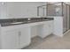 Elegant bathroom with double sinks, gray countertops, and a frameless glass shower at 2884 Nottel Dr, St Cloud, FL 34772
