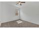 Carpeted bedroom featuring a ceiling fan and a window allowing natural light at 2884 Nottel Dr, St Cloud, FL 34772