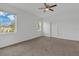 Serene bedroom with carpet floors, large windows, and a ceiling fan at 2884 Nottel Dr, St Cloud, FL 34772