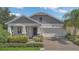 Charming single-story home features a covered front porch, 2-car garage, beautiful landscaping, and neutral paint colors at 2884 Nottel Dr, St Cloud, FL 34772