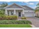 Attractive home with a well-manicured lawn, a covered porch, and a brick driveway at 2884 Nottel Dr, St Cloud, FL 34772