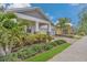Charming home featuring lush landscaping, a brick driveway, and an inviting covered porch at 2884 Nottel Dr, St Cloud, FL 34772