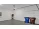 Spacious garage featuring modern flooring, trash bins, and a wall-mounted electrical panel at 2884 Nottel Dr, St Cloud, FL 34772