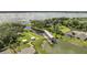 A serene lake view featuring a covered dock, inviting seating areas, and lush landscaping surrounding beautiful homes at 2884 Nottel Dr, St Cloud, FL 34772