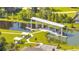 A serene lake view featuring a covered dock, inviting seating areas, and lush landscaping, perfect for relaxation at 2884 Nottel Dr, St Cloud, FL 34772