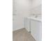 Bright laundry room with modern appliances, white walls, and neutral tile flooring, offering a clean and functional space at 2884 Nottel Dr, St Cloud, FL 34772
