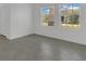 Bright living room with two large windows, white walls, and ceramic tile flooring at 2884 Nottel Dr, St Cloud, FL 34772
