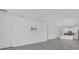 Spacious living room with ceramic tile flooring, white walls, and a kitchen view at 2884 Nottel Dr, St Cloud, FL 34772