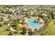 Aerial view of a community pool with lounge chairs, palm trees, and a splash pad at 2884 Nottel Dr, St Cloud, FL 34772
