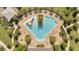 Aerial view of a community pool with a colorful splash pad and lounge chairs at 2884 Nottel Dr, St Cloud, FL 34772