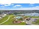 A beautiful aerial view of the community pool, playground, and surrounding homes by the lake at 293 Pineywoods St, St Cloud, FL 34772