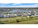 Beautiful aerial view of community homes near a tranquil lake and lush green spaces, highlighting peaceful living at 293 Pineywoods St, St Cloud, FL 34772
