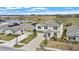Aerial view of a two-story house with a pool, solar panels, and landscaping in a suburban community at 293 Pineywoods St, St Cloud, FL 34772