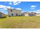 Expansive backyard featuring lush green grass and a view of neighboring homes, offering a serene outdoor space at 293 Pineywoods St, St Cloud, FL 34772