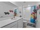 bathroom with white cabinets, a single sink, and a playful Paw Patrol themed shower curtain at 293 Pineywoods St, St Cloud, FL 34772