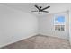 Neutral-toned bedroom with a large window that fills the room with natural light at 293 Pineywoods St, St Cloud, FL 34772